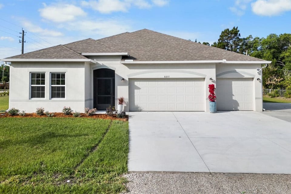 Large yard and 3 car garage with plenty of driveway parking