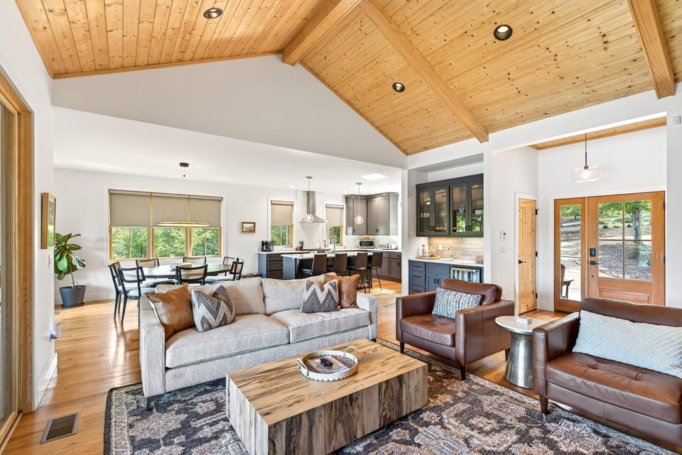 Open-concept living area with gas log fireplace, Roku TV for streaming, and access to the deck