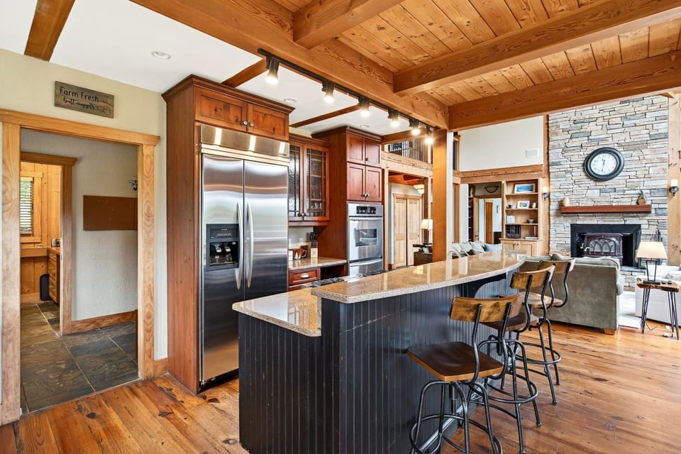Well-equipped kitchen with gas range, drip-style coffee maker, dining area for 8, and island seating for 3