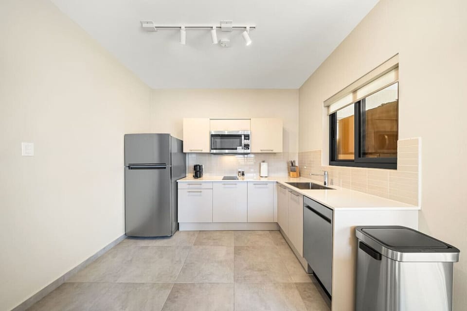 A chef`s dream. This pristine, contemporary kitchen features premium stainless steel appliances, seamless white cabinetry, and durable countertops crafted for both high style and everyday utility.