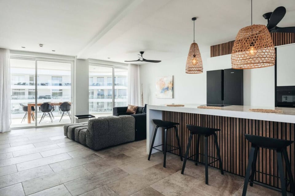 Delight in this modern kitchen featuring chic design and cozy seating, ideal for culinary adventures and memorable gatherings.