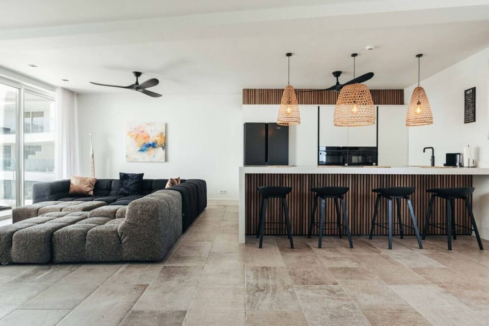 Relax in this beautifully designed open space, featuring a cozy lounge and sleek kitchen, perfect for enjoying quality time with friends and family.