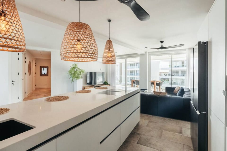 Enjoy a stylish retreat in this bright, modern kitchen and living area, perfect for entertaining and relaxation during your beach getaway.