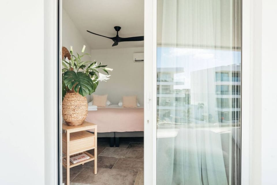 Enjoy a cozy retreat in this beautifully styled bedroom, featuring elegant decor and refreshing views.