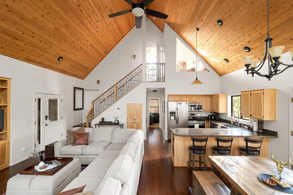 Whether you're whipping up a feast in the spacious kitchen, gathering around the stone fireplace, or simply soaking in those panoramic window views, this is where comfort and grandeur unite. Your stylish forest escape starts here!