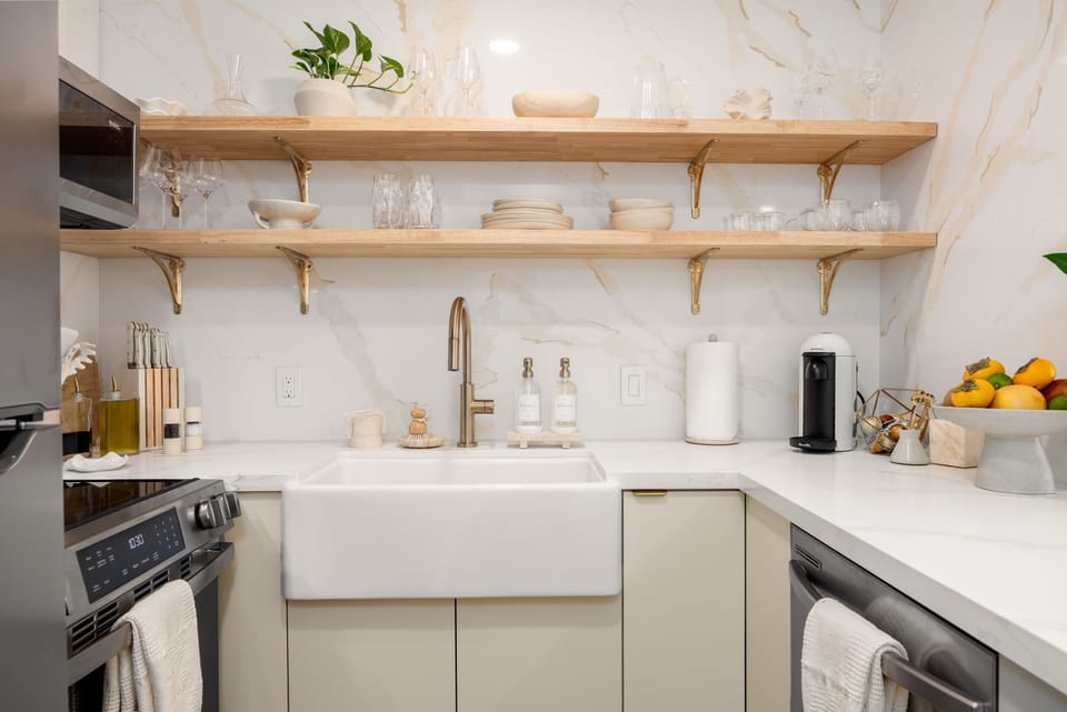 Modern kitchen with open shelving, sleek finishes, and curated essentials.