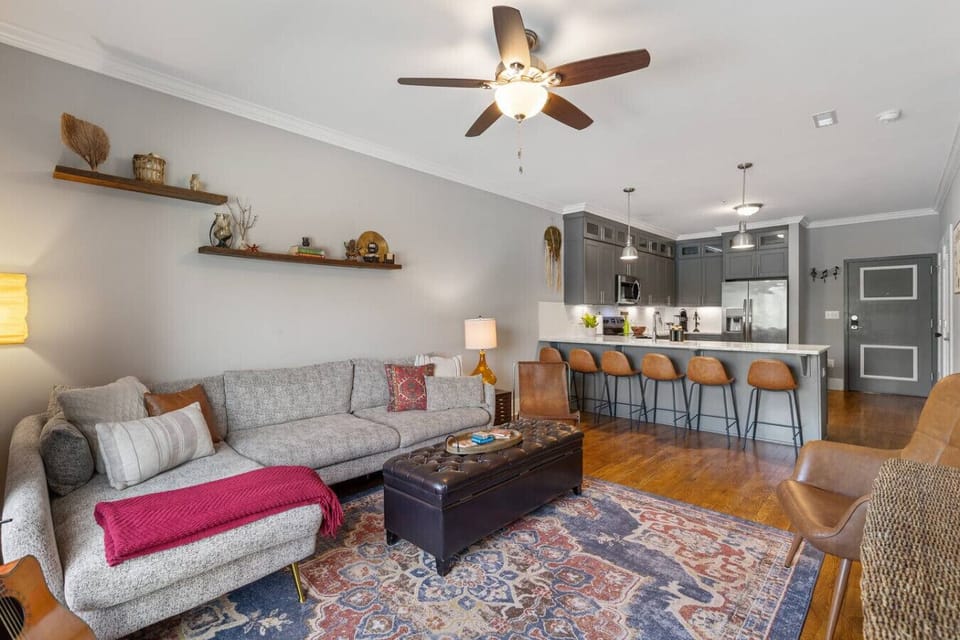 Spacious living room with queen pull-out couch and a Smart TV for your entertainment. Enjoy your morning coffee with plenty of natural light.