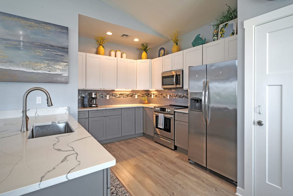 Fully equipped modern kitchen with stainless appliances.