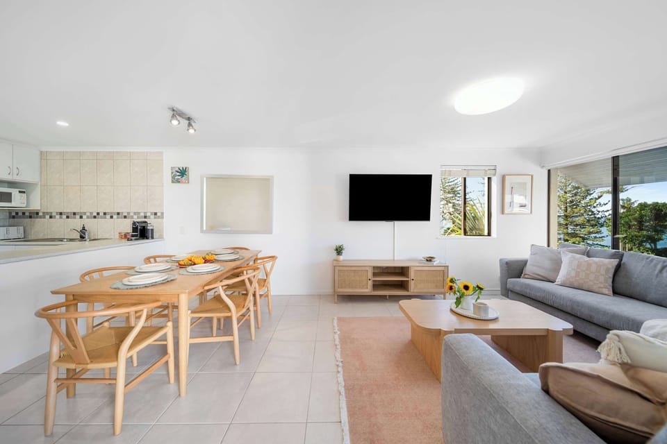 Move easily between living, dining, and kitchen zones in this open-plan space designed for relaxed coastal days.