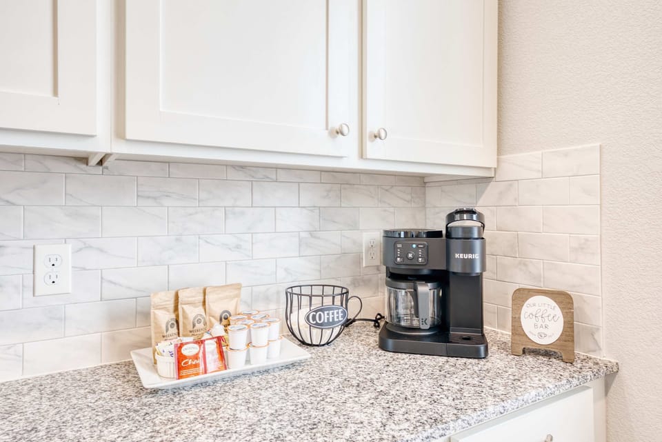 Dedicated coffee station with Keurig & drip brewer, mugs, and supplies to start your day right.
