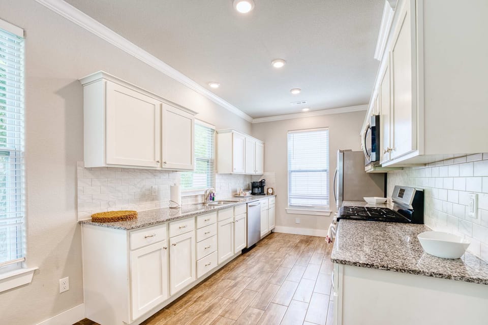 Chef’s kitchen with stainless appliances, granite counters, and a coffee bar stocked for morning brews.