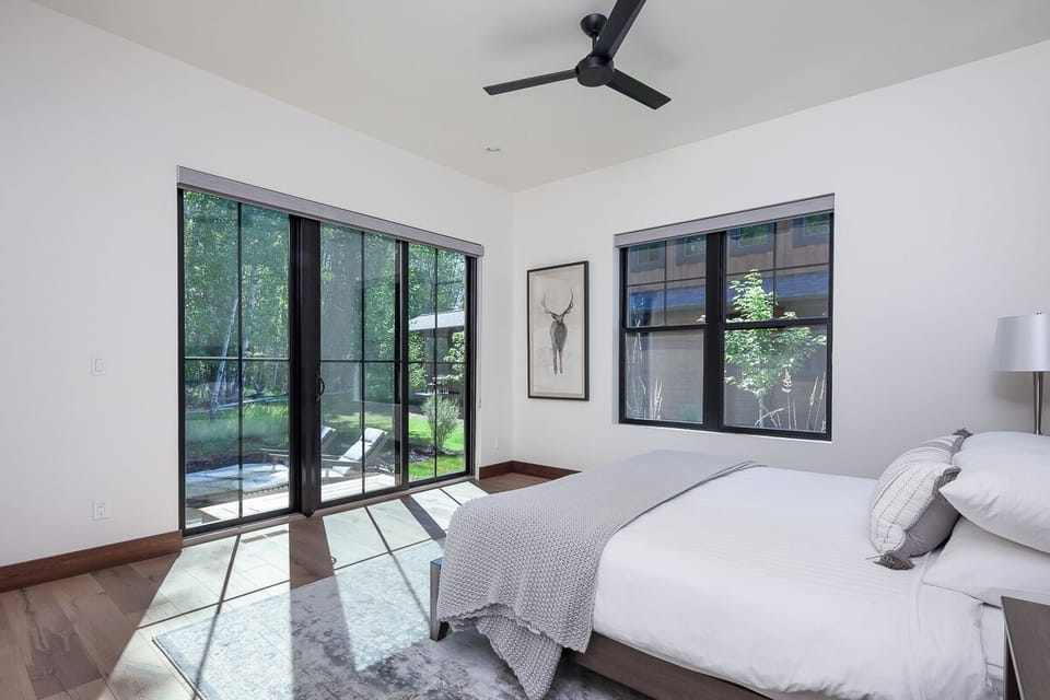 Wake up to sunshine and garden views through glass doors.