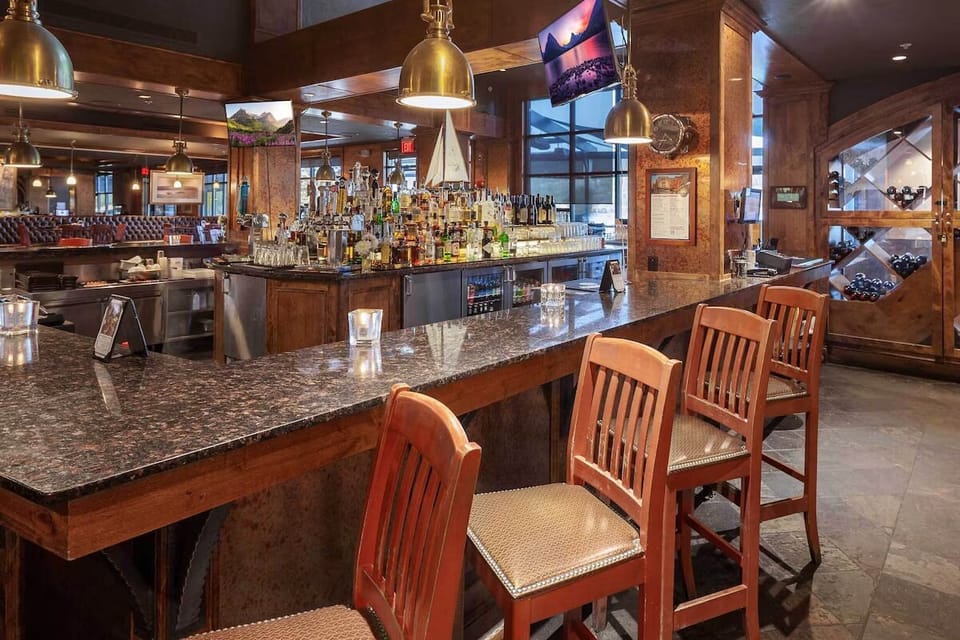 Unwind with a nightcap at the warm, wood-lined bar.