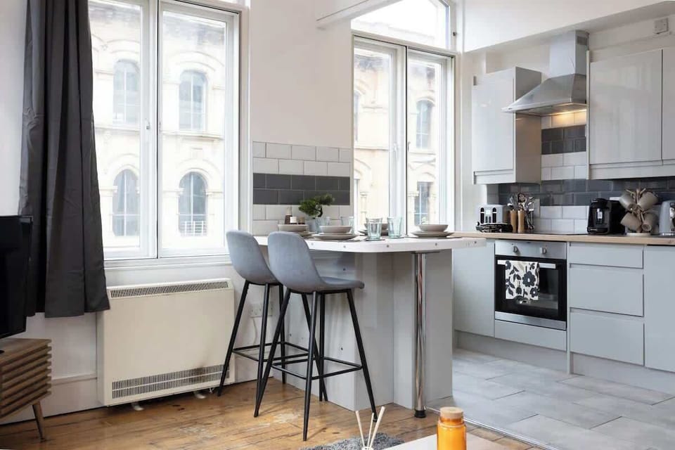 A sleek modern kitchen with breakfast bar, oven, and everything you need to whip up meals during your stay