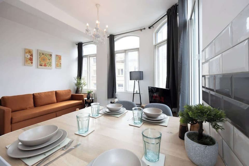 Enjoy meals together at the dining table with views through the tall windows flooding the space with natural light