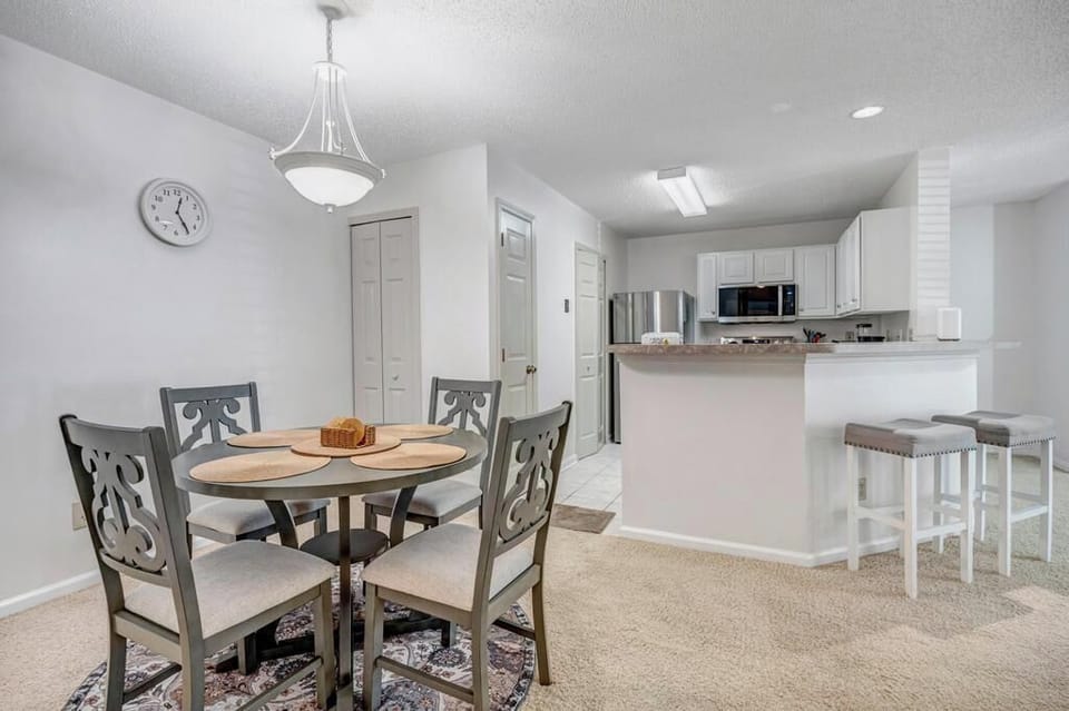 Dining area w/ modern lighting and a clean, open feel