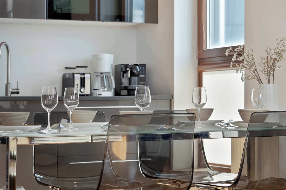 A kitchen countertop with a coffee machine, sink, and organized utensils. The area is compact yet highly functional for daily use.
