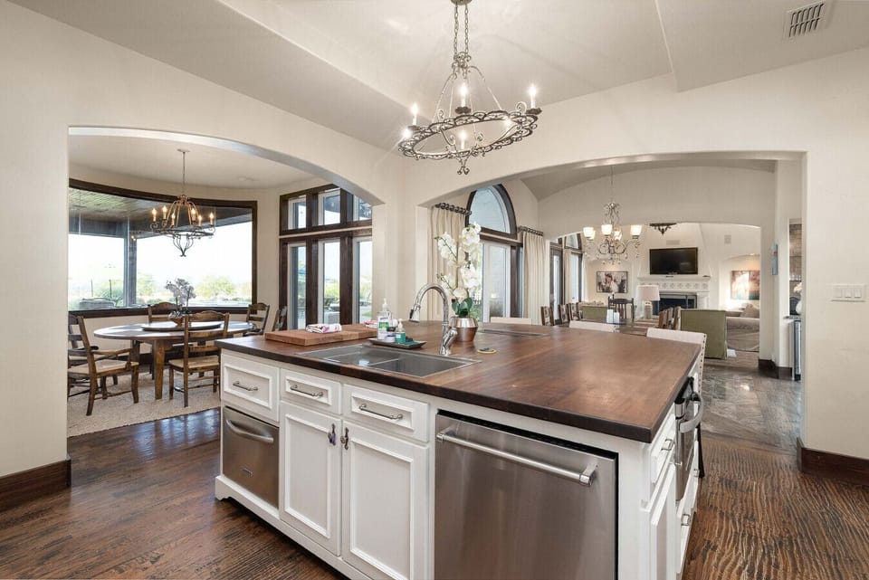 Spacious kitchen with custom island and views to indoor and outdoor dining
