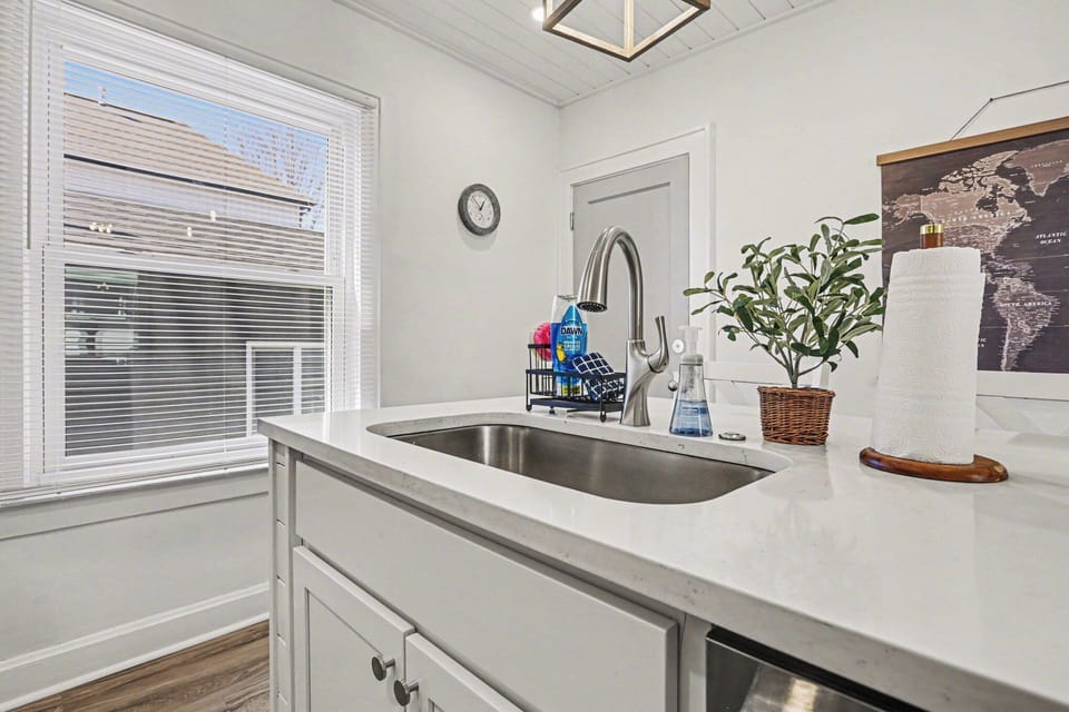 Bright kitchen sink with window and prep space