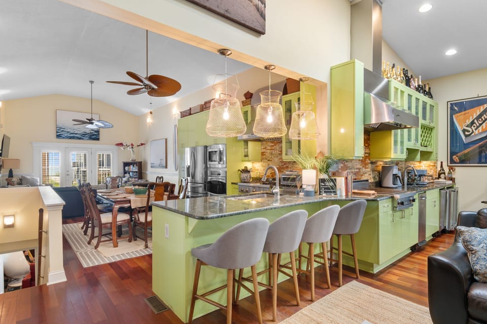 Your vibrant kitchen island becomes the heart of culinary adventures, with sleek granite counters and stylish seating perfect for morning coffee or evening gatherings.