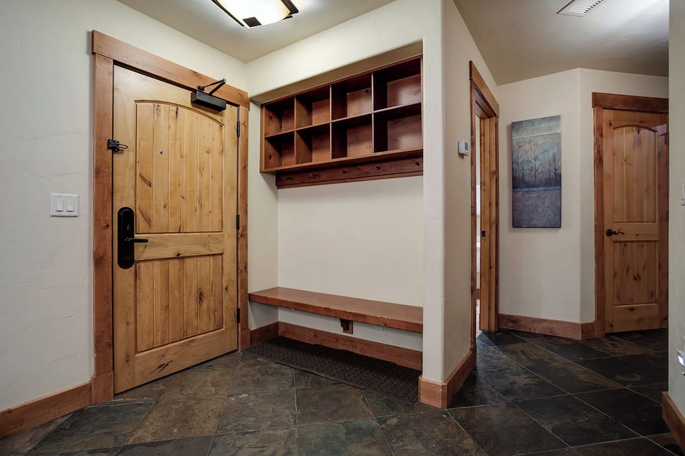 Your mudroom welcomes you with custom wood storage cubbies and a bench, perfect for organizing gear after mountain adventures.