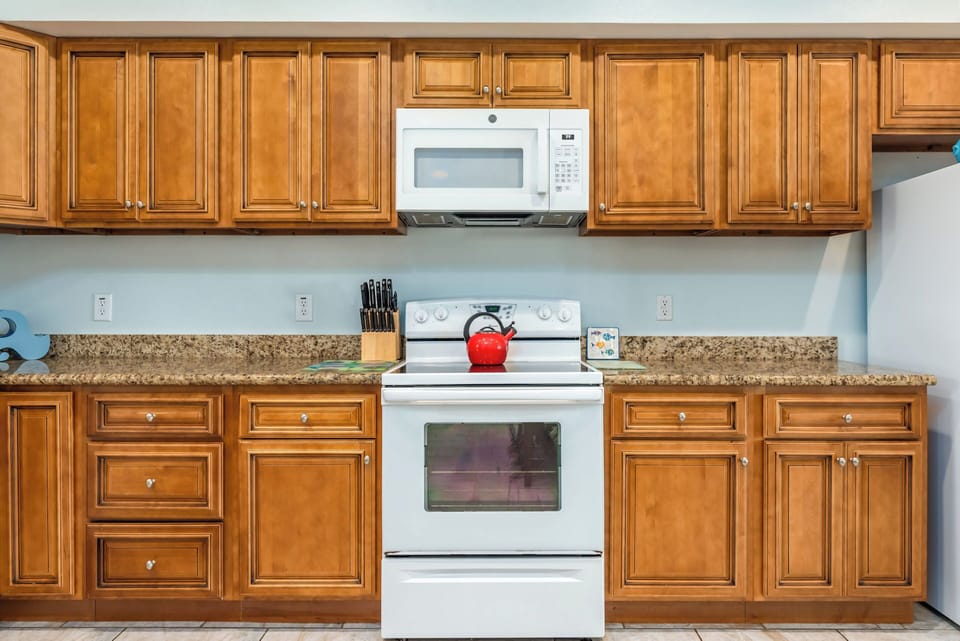 Cook memorable meals in your fully equipped kitchen with granite counters, classic wood cabinets, and modern appliances.