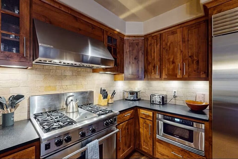 Kitchen - Fully appointed with stainless steel gas Wolf range w/griddle, microwave, dishwasher and Wolf refrigerator