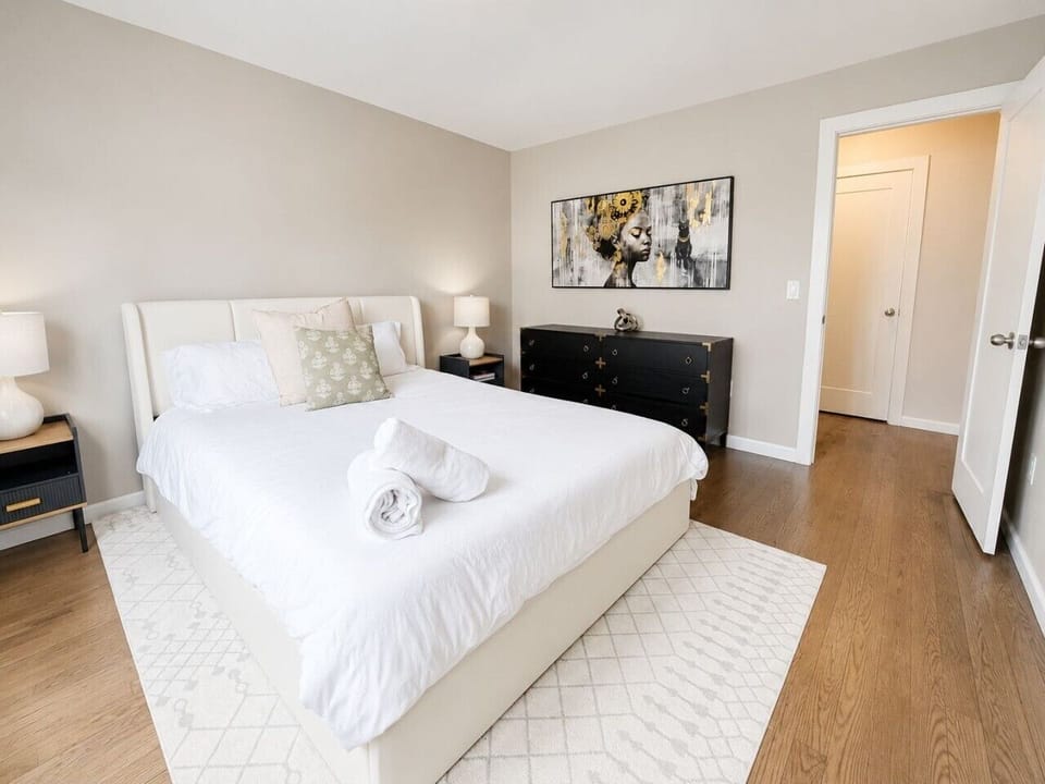 Bright bedroom with a comfortable queen bed and natural light.