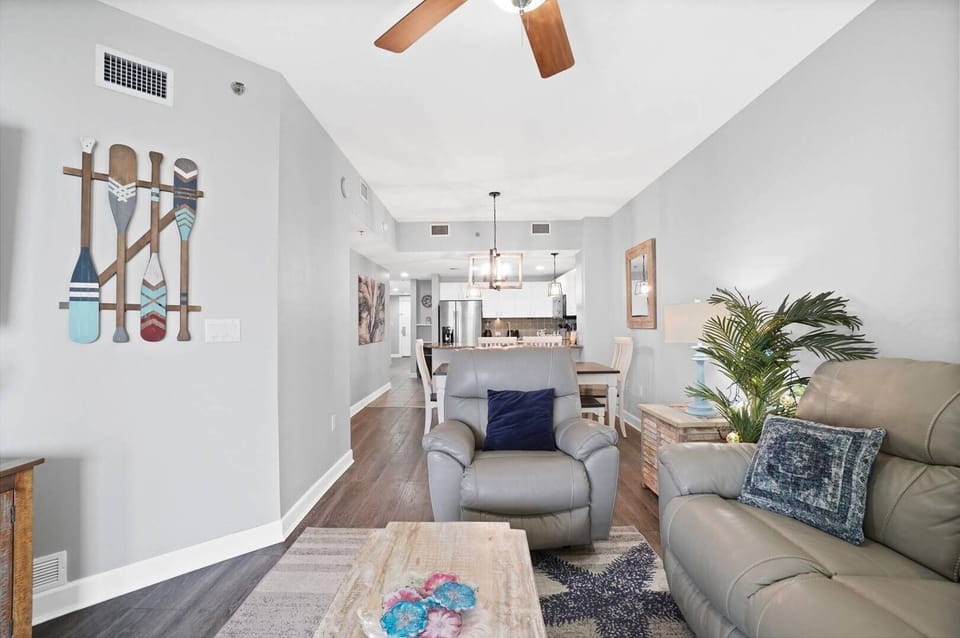 Relax in your bright, open living space with coastal charm, comfy seating, and seamless flow to the kitchen.