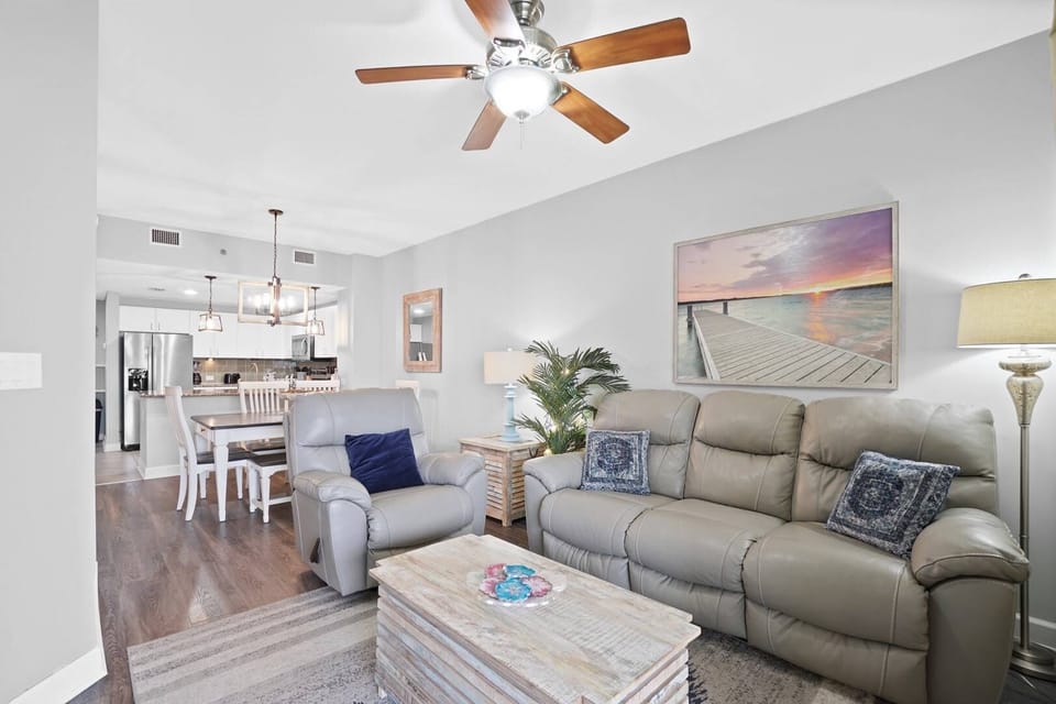 Unwind in your bright, open living space with plush seating and coastal art that brings the beach vibes indoors.