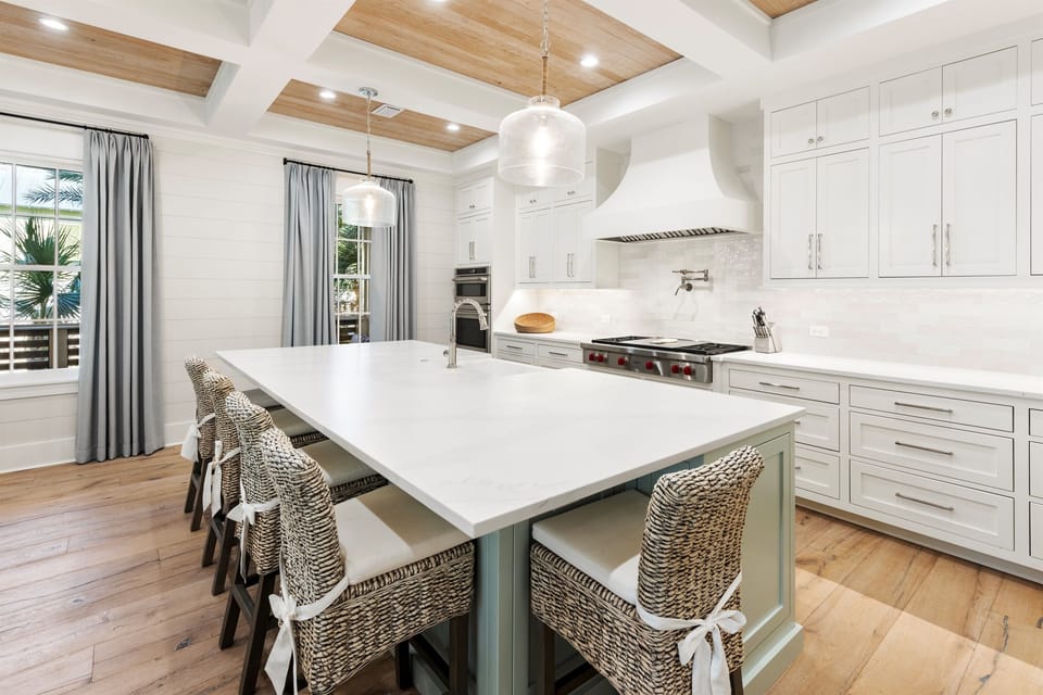 Your chef-inspired kitchen awaits with spacious island, premium appliances, and warm wood ceiling beams creating the perfect space for memorable meals.