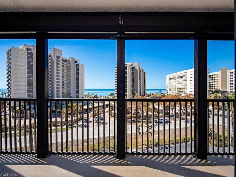 Private balcony with sweeping Gulf and bay views across from Vanderbilt Beach