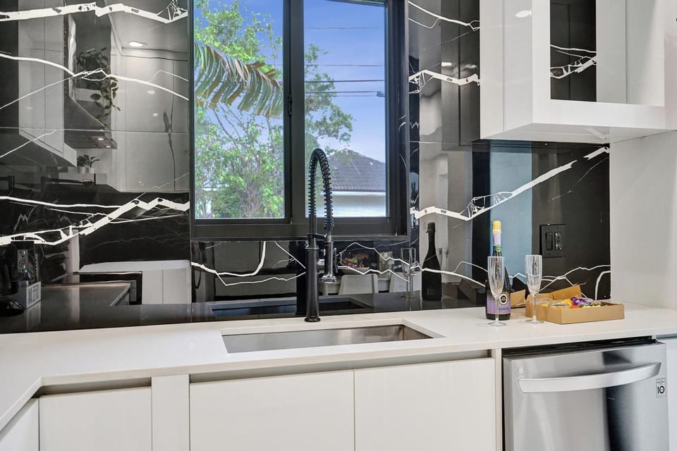 Sink with a garden view and dishwasher for easy cleanup.