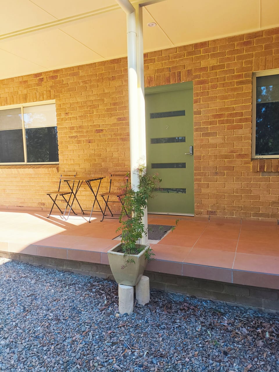 Outdoor table with 2 chairs and ashtray. Please smoke or vape outside