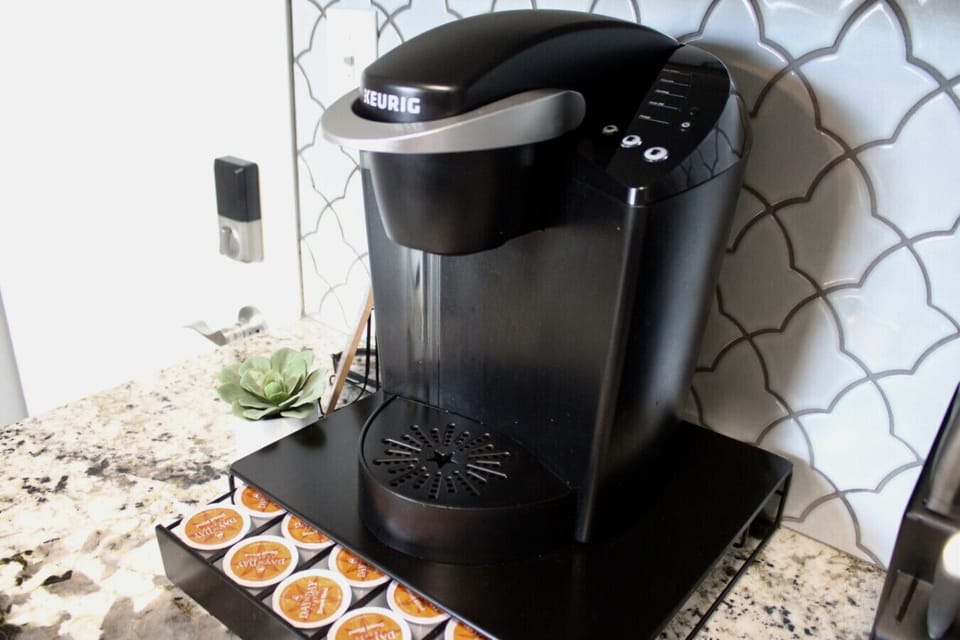 Coffee Corner: Brew your perfect cup with our stylish Keurig and variety of pods.