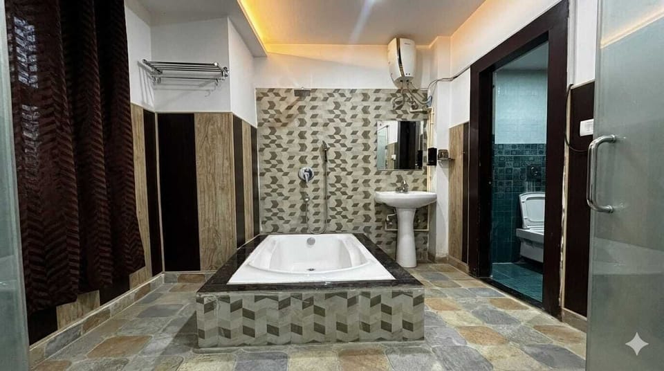 Luxury Studio Suite | Bathroom | Hair dryer, slippers, towels, soap