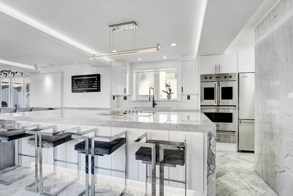 3rd FLOOR: KITCHEN. 30 foot island. Viking appliances (double oven, warmer, full fridge, wine fridge, dishwasher, drawer microwave, 6 burner cooktop with retractable vent, dishwasher), built-in Miele espresso machine. 48 inch sink. 