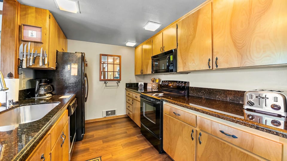 Galley kitchen with upgraded countertops and appliances