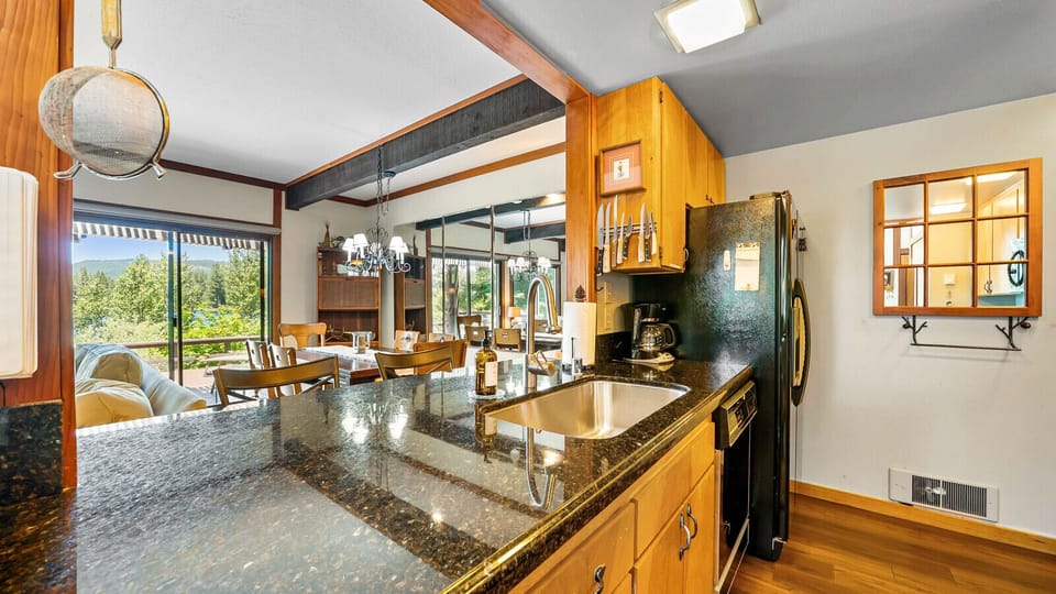 Kitchen opens to living with stunning views