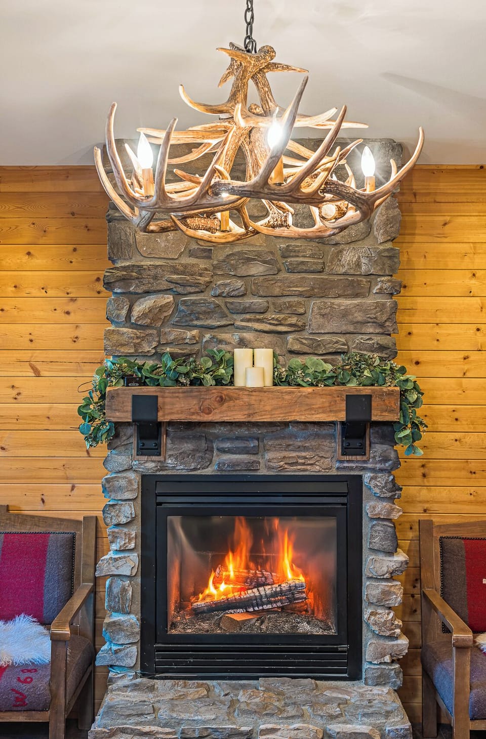 Gather by the fire under rustic chandeliers for cozy mountain nights