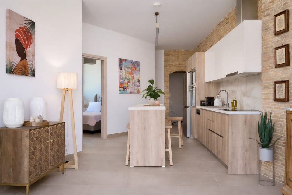 The ground floor features two bedrooms, and an open plan living & kitchen area.