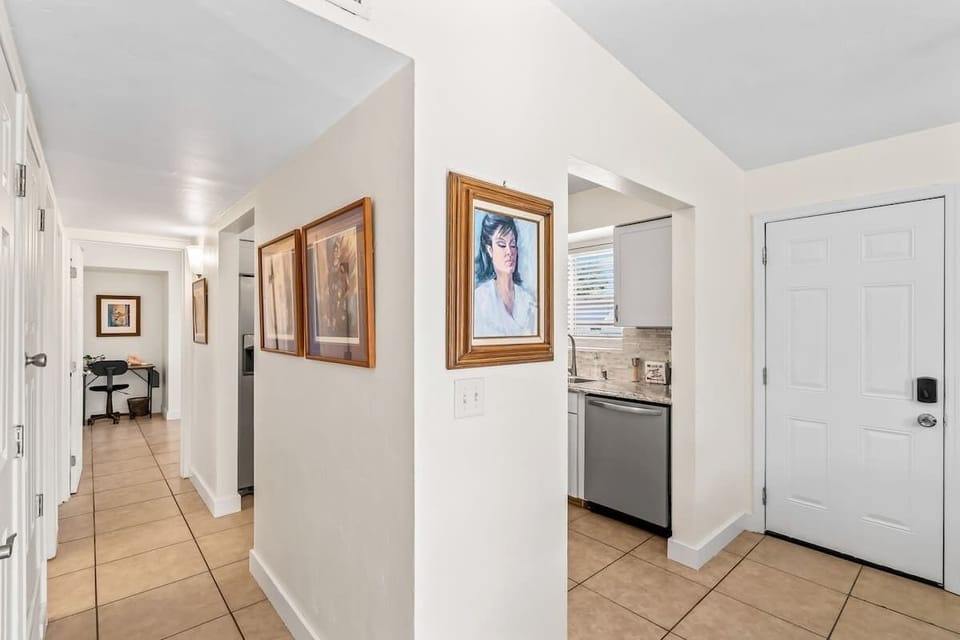 Step into a bright, thoughtfully decorated hallway adorned with curated art pieces that lead you into a warm and inviting stay. Every corner designed with charm and comfort in mind.
