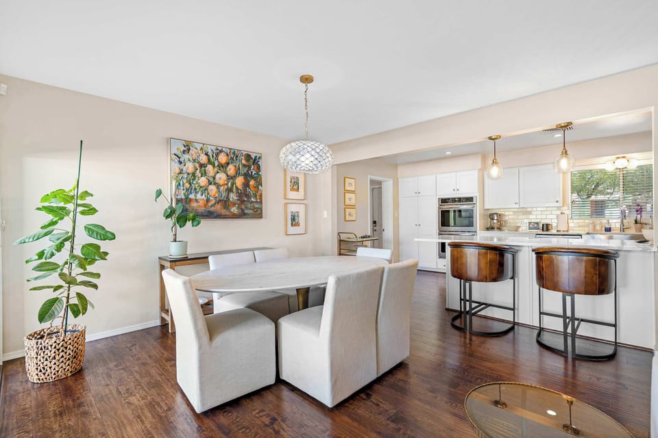 Dining area for six, complemented by a cozy breakfast nook, offering versatile seating options for meals or morning coffee.