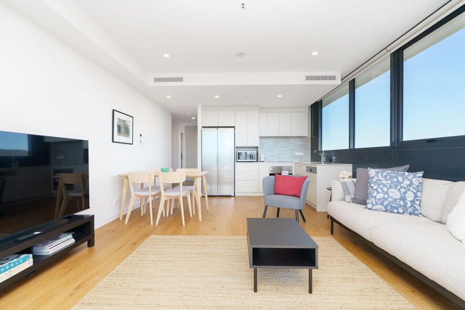 Enjoy comfort and relaxation in this sunlit living room, complete with space for effortless entertainment