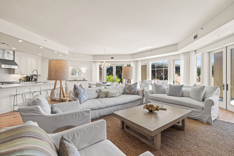 Sink into luxurious comfort in this bright, airy living space where plush sofas and natural textures create your perfect retreat.