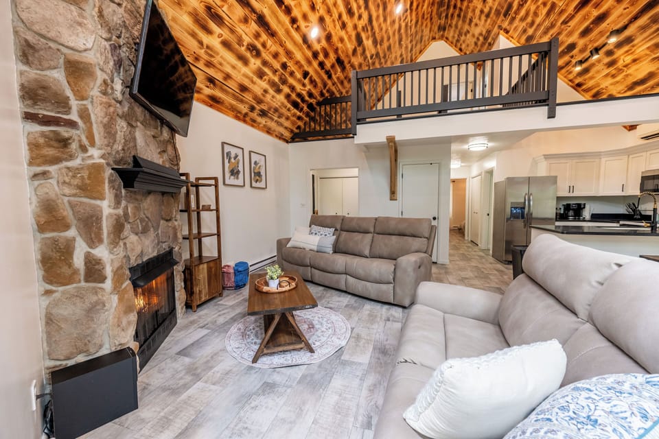 Cozy living room with fireplace and reclining couches