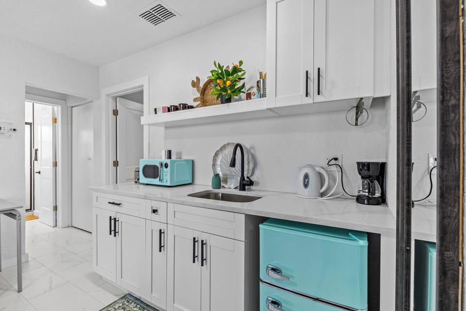 Kitchen with microwave, portable stove, coffee, and tea maker