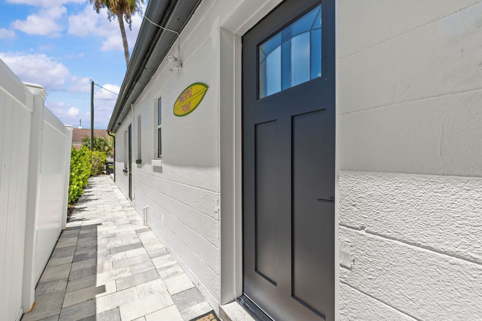 Front door on south side of building facing open lot.