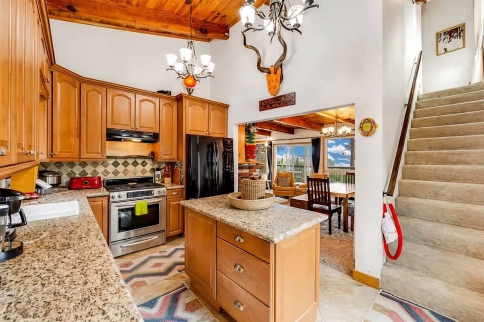 Cozy up under wood beam ceilings with plush seating, a large smart TV, and mountain-inspired décor.