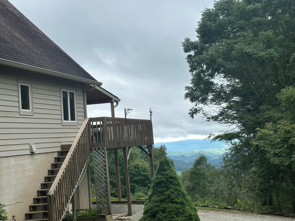 As you park, you will see this set of stairs to the deck and front door. To avoid the stairs, go around the home on the right side.